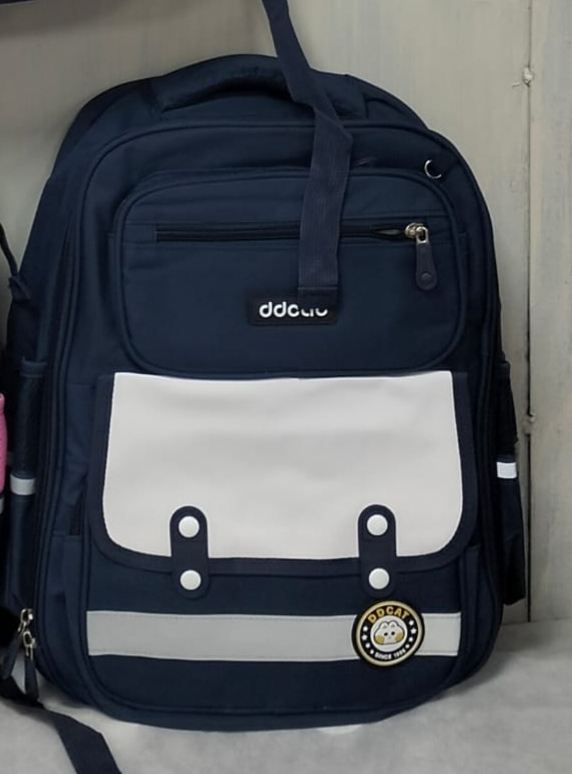 Navy blue school backpack with white front pocket and multiple compartments