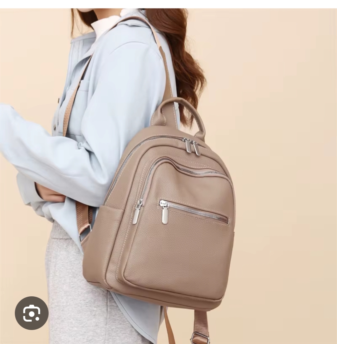 Elegant taupe leather backpack with silver zippers, designed for stylish women travelers – perfect for luxury day trips