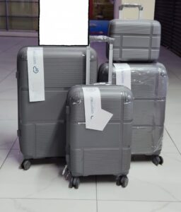 Set of 4 gray textured hard shell suitcases with spinner wheels, including carry-on and travel bag.