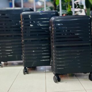 Black hard-shell 3-piece luggage set with horizontal stripe design, spinner wheels, and telescopic handles.