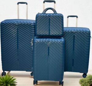 4-piece blue hard shell luggage set with chevron pattern, including large suitcases, carry-on, and travel bag