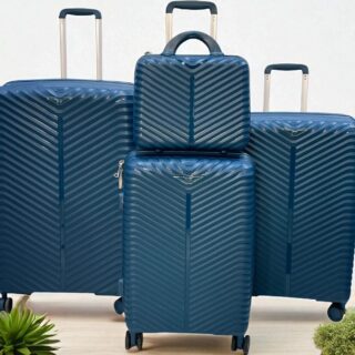 4-piece blue hard shell luggage set with chevron pattern, including large suitcases, carry-on, and travel bag