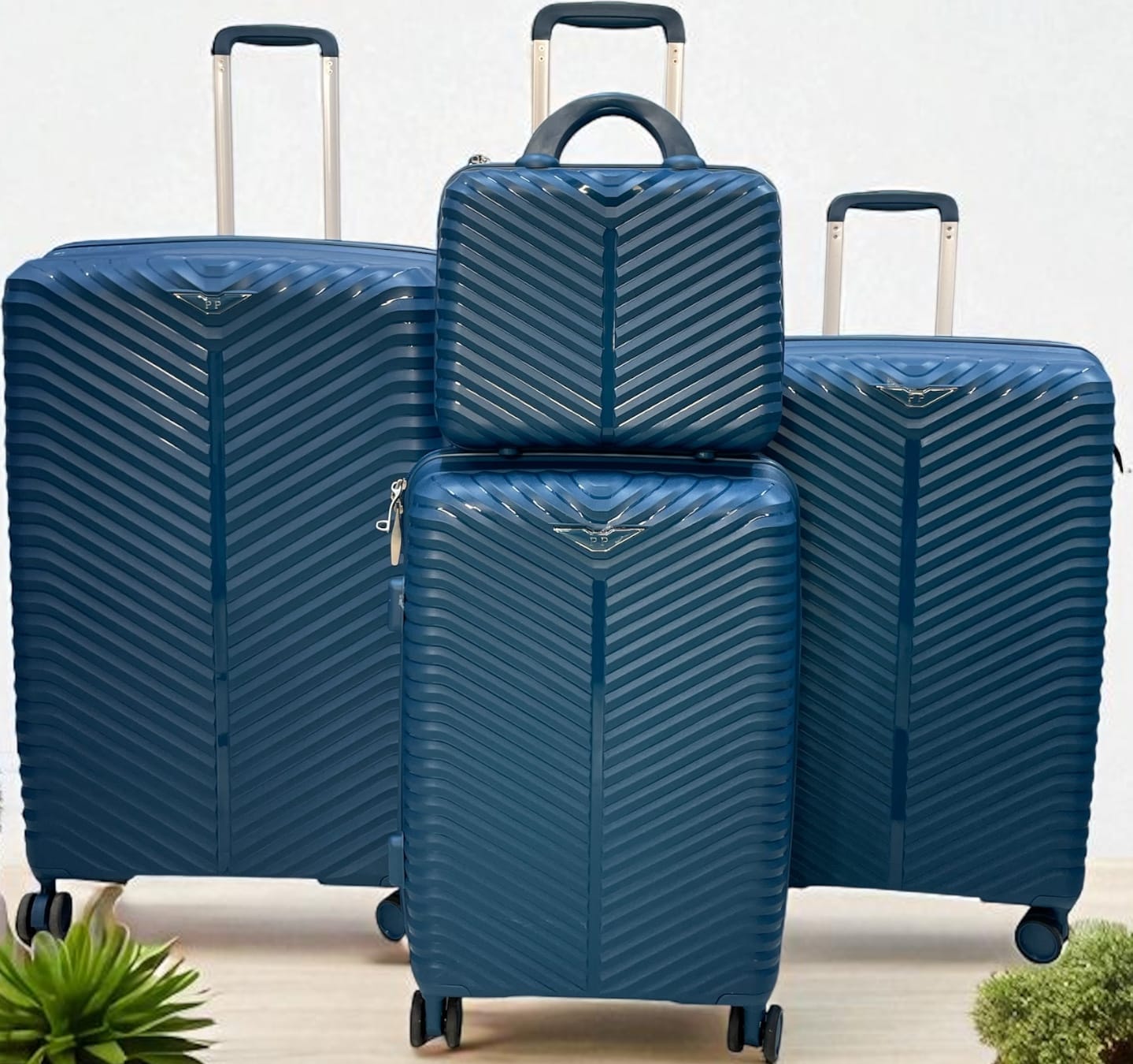 4-piece blue hard shell luggage set with chevron pattern, including large suitcases, carry-on, and travel bag