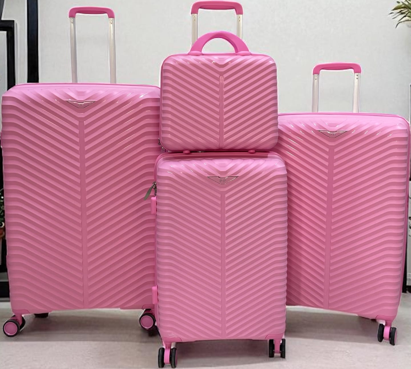 A set of 4 Bubblegum Pink hard-shell rolling suitcases
