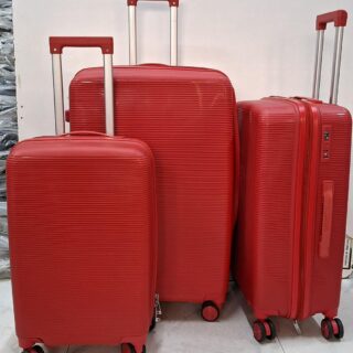 Three red hard-shell rolling suitcases of different sizes with telescopic handles