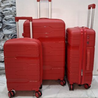A set of three red hard-shell rolling suitcases in large, medium, and small sizes.