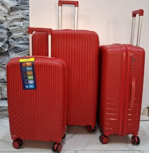 A set of three red hard-shell rolling suitcases in large, medium, and small sizes.