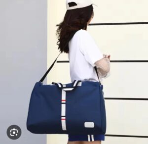 Navy blue duffel bag with striped design, shoulder strap
