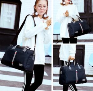 Black duffel travel bag with striped design and dual handles