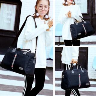 Black duffel travel bag with striped design and dual handles